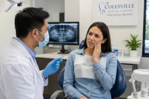 Patient experiencing tooth pain that may be a sign of root canal symptoms
